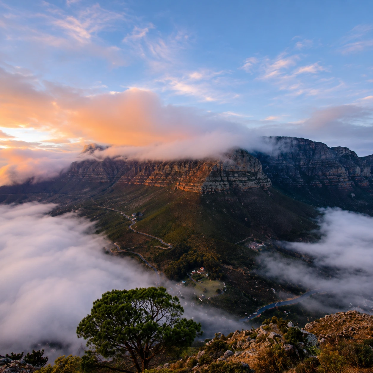 Sunrise clouds rolling over Table Mountain with panoramic views of Cape Town.