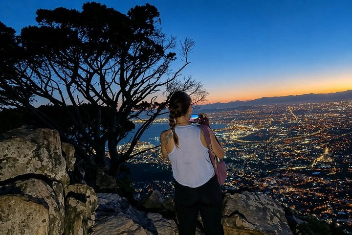 Hikers watching the sunrise from Lion's Head in Cape Town